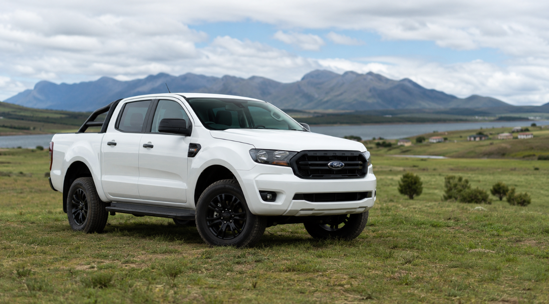 White Ford Ranger double-cab on a South African farm landscape with mountains, featured in Northly's wireless CarPlay and Android Auto guide for Ranger and Everest owners