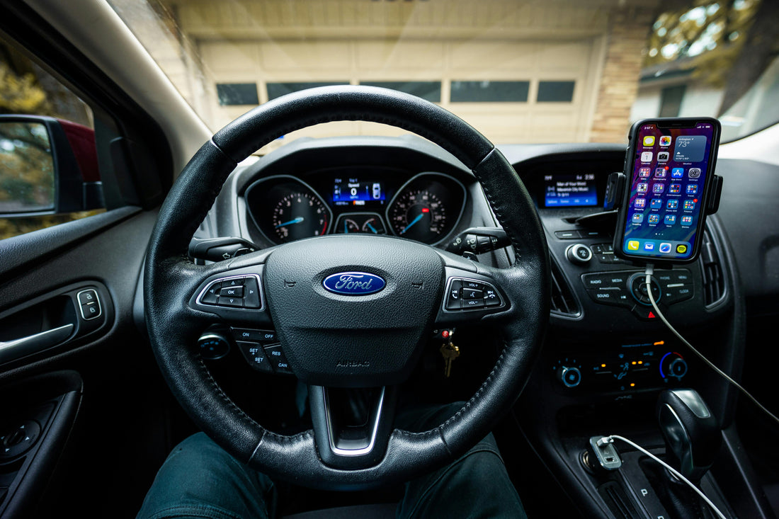Smartphone mounted in a Ford car interior next to the dashboard, showing the wireless CarPlay and Android Auto connection between phone and car infotainment in South Africa