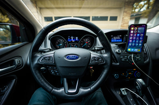 Smartphone mounted in a Ford car interior next to the dashboard, showing the wireless CarPlay and Android Auto connection between phone and car infotainment in South Africa